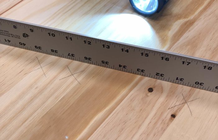 Use a flashlight and straight edge to identify areas of your project that need to be flattened by a sander