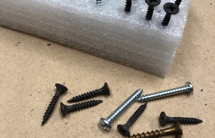 Use a piece of packing material to organize screws during an assembly project.