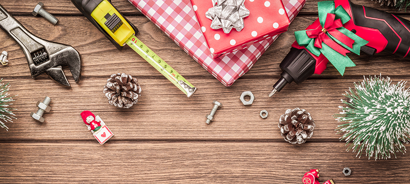 Tools laying on a wood table with presents.